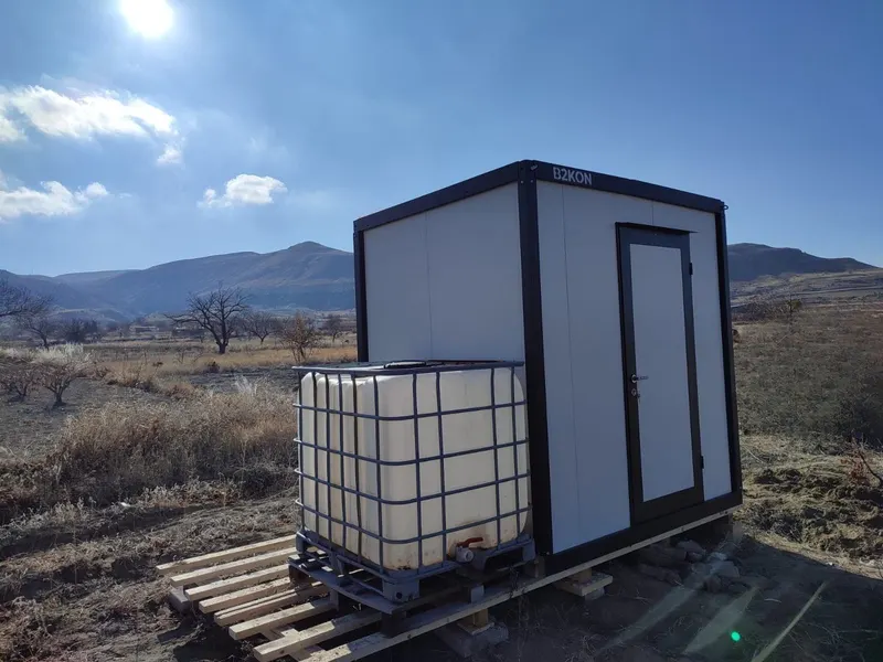 A B2KON portable restroom unit on a construction site